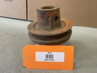 Allis-Chalmers Used Allis-Chalmers WD WD45 Crankshaft Pulley, used and rusty with some paint markings, placed on a gray surface.