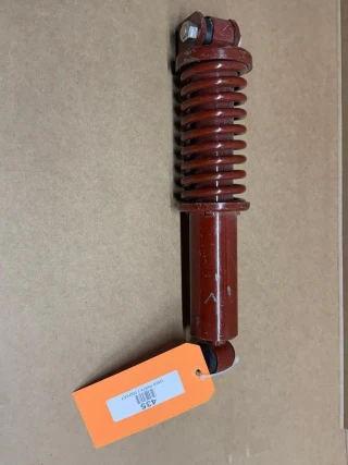 Allis Chalmers WD CA Seat Shock Absorber with Spring, display model, red color, vertical orientation.