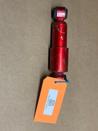Tractor Seat Shock Absorber for Monroe Seat, display image of a red, worn-out shock absorber with a label tagged 436, used for vehicle seat suspension and comfort enhancement.
