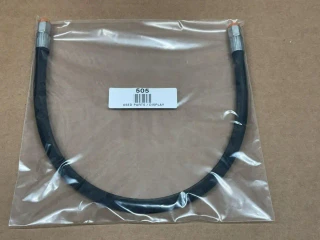 Allis Chalmers D14 D15 Fuel Line, display of used fuel line with metal fittings in clear plastic packaging.