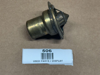 Thermostat 160 Degrees for Allis-Chalmers and More, display model of a used mechanical thermostat with metal housing and mounting flange on a brown background.