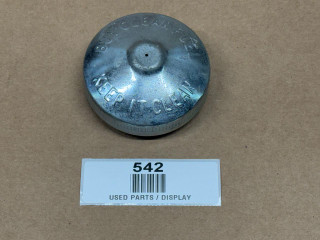 Top Vented Fuel Cap With Gasket (Display), metallic fuel cap with engraved text and a small hole in the center, used for vehicle fuel tanks