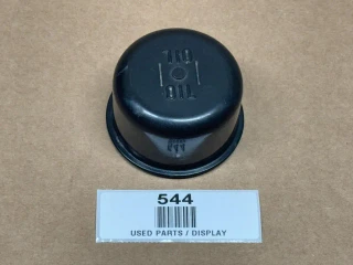 Oil Fill Breather Cap with Clip for Allis-Chalmers, display of a black oil fill breather cap placed on a brown surface with a numbered label underneath.