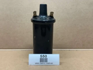6 Volt Distributor Coil AB-011D, display model of a black ignition coil with electrical connectors on top on a cardboard surface