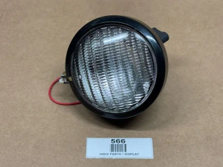 Allis Chalmers 12V Sealed Beam Combo Tail Light Assembly, display image of a round black and clear sealed beam tail light with wiring, used for agricultural or industrial vehicles.