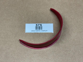 Light Visor for Allis-Chalmers D10 D12 D15 D17 D19, display view of a red curved plastic part on a brown cardboard surface with a label that reads 'USED PARTS / DISPLAY' and the number '575'.