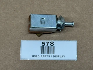 Allis-Chalmers 2-Position Light Switch AC-290D 228330, display view of used electrical switch part lying on brown surface with a white label underneath.