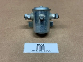 Starter Solenoid 3 Post Saddle Mount 12 Volt, used electrical starter solenoid compact metal component with multiple connection ports on a brown surface.