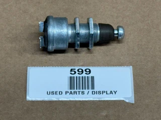 Neutral Safety Starting Switch OEM 70248659, display of the used vehicle part with metallic and black components on a brown background.