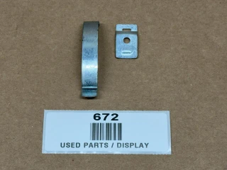 Delco Distributor Cap Spring Clip With Longer Bracket, used automotive distributor parts, display of two metal components on a brown background.