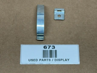 Delco Distributor Cap Spring Clip AB-488SD, display of a metal spring clip and its mounting plate on a brown surface with a label.