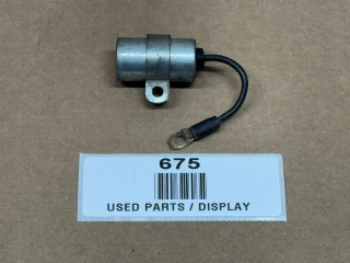 Fairbanks Morse FMJ FMX Magneto Condenser, used part with metal cylindrical body and attached black wire with ring terminal connector.