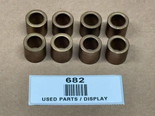 Allis Chalmers Bronze Seat Bushings Set 70227910 227910, display of ten used bronze bushings for heavy machinery.