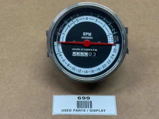 A circular tachometer operation meter for Allis-Chalmers farm tractors. It has a black face with white and blue markings and a red needle, showing RPM in hundreds and hours at 2200 RPM. The display window shows the hours as 3.