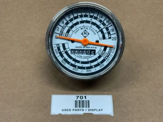 Allis-Chalmers D17 Diesel Tachometer / Operation Meter AC-1505D with a white dial, black and orange markings, and multiple scale readings in miles per hour, engine RPM, and hours at 1650 RPM, mounted in a circular metal housing.