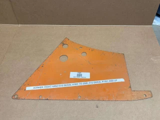 A worn, orange right-hand side panel for Allis-Chalmers farm tractors, specifically for D10 and D12 models, with multiple holes for fittings, placed on a cardboard surface.
