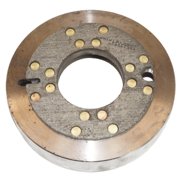 Close-up of a round Allis-Chalmers tractor brake drum with a gray riveted friction lining, large center opening, and a smaller mounting hole on one side.