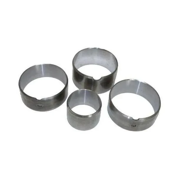 Four silver-gray metal camshaft bearing bushings arranged together on a white background.