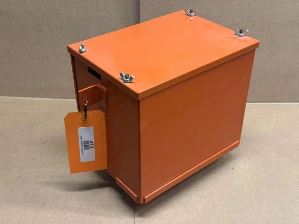Allis Chalmers B C CA Battery Box (Display), a rectangular orange battery box with four metal wing nuts on top and a small hanging orange tag with bar code.