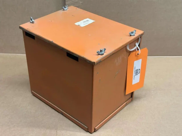Allis-Chalmers D10 D12 Battery Box with Lid 233332, orange metal battery container with four bolts on top and a white wire attached to a shipping tag.