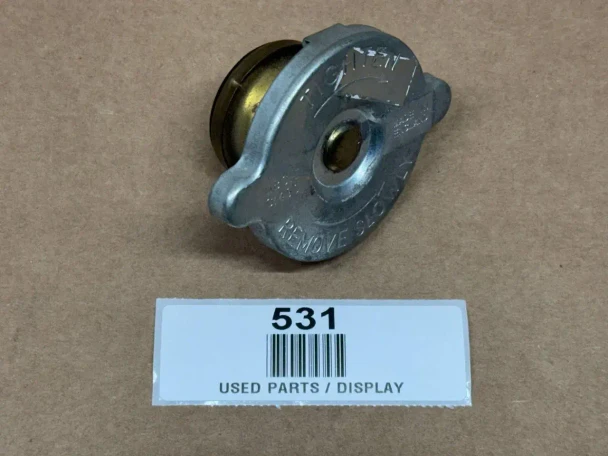 7 PSI Radiator Cap for Allis Chalmers, Case, Ford, IH, John Deere, display of radiator cap on a brown background.