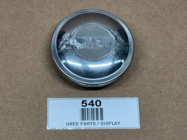 Fuel Cap for Allis-Chalmers, Case, Ford, JD, and Massey, display of a used metal fuel cap on a cardboard surface with a label reading 540 and used parts display.