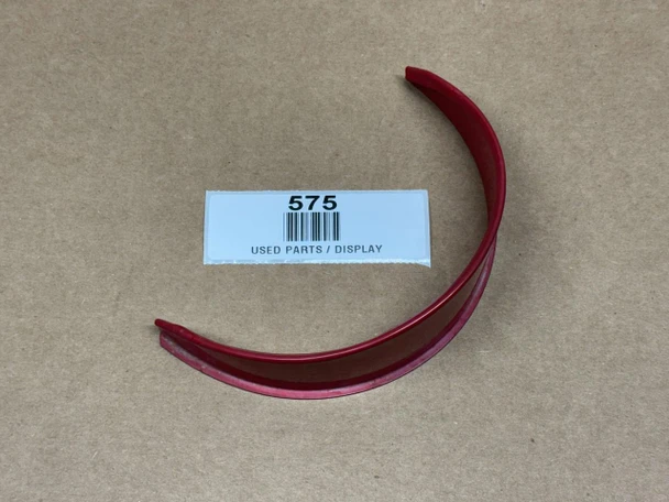 Light Visor for Allis-Chalmers D10 D12 D15 D17 D19, display view of a red curved plastic part on a brown cardboard surface with a label that reads 'USED PARTS / DISPLAY' and the number '575'.