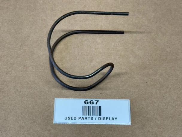 Allis-Chalmers Snap Coupler Bell Hook Spring 70226514, used part displayed on a brown surface with a label below indicating it's for display.