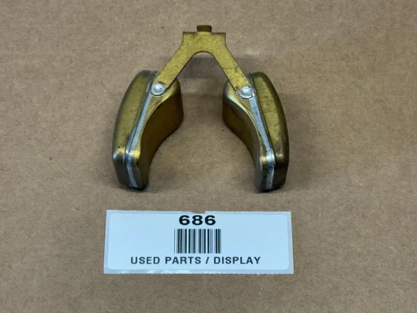 Marvel Schebler Carburetor Float for Allis-Chalmers D19, used part display showing a metallic carburetor float with a yellowish finish placed on a brown surface.