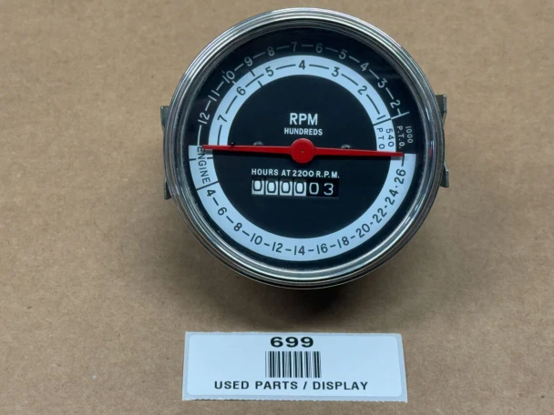 A circular tachometer operation meter for Allis-Chalmers farm tractors. It has a black face with white and blue markings and a red needle, showing RPM in hundreds and hours at 2200 RPM. The display window shows the hours as 3.