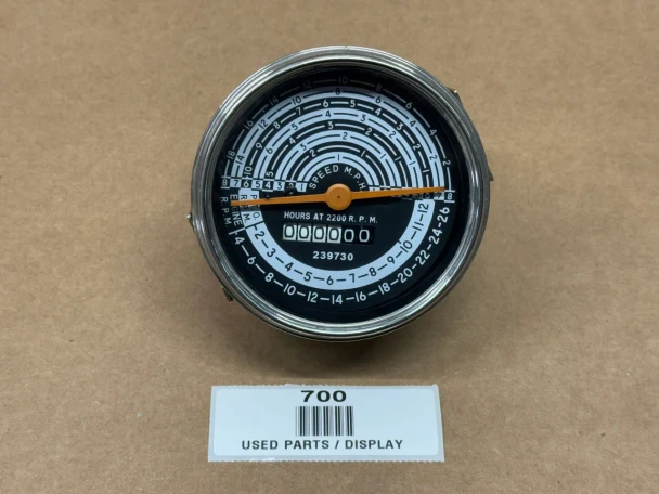 A round tachometer operation meter display for Allis-Chalmers D21 farm tractors, featuring black background with white and orange markings, and a digital hour counter at the bottom.