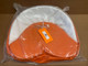 Orange and White Tractor Seat Pad Cushion 19 inches, displayed in a plastic packaging for sale or display.