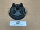Allis-Chalmers Distributor Cap Delco ACR1944, display view of a used black distributor cap with five connection points, placed on a plain surface.