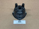 Distributor Cap ACR1954, black plastic engine distributor cap with multiple ignition wire connectors, used automotive part displayed on a plain surface.