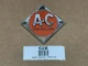 Persian Orange #1 Emblem for Allis-Chalmers Steering Wheel and Front Nose, display of a vintage metal emblem with orange and silver colors, featuring large letters A-C and the words Allis-Chalmers.