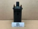 6 Volt Distributor Coil AB-011D, display model of a black ignition coil with electrical connectors on top on a cardboard surface