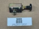 Universal 2 Position Push/Pull Light Switch, 30 Amp, display, showing a metal switch with black handle, mounting screws, and toggle mechanism on a brown surface with a used parts display label.