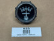 Universal Ammeter Gauge (20-0-20), display of an analog ammeter with a black dial and white markings for discharge and charge, used for measuring electrical current in amperes.