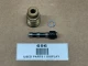 A used Allis Chalmers D19 distributor tach drive cable adapter, consisting of a threaded metal component, a small flat washer, a drive shaft with a gear on one end, all laid out on a brown surface with a label reading 'USED PARTS / DISPLAY'.