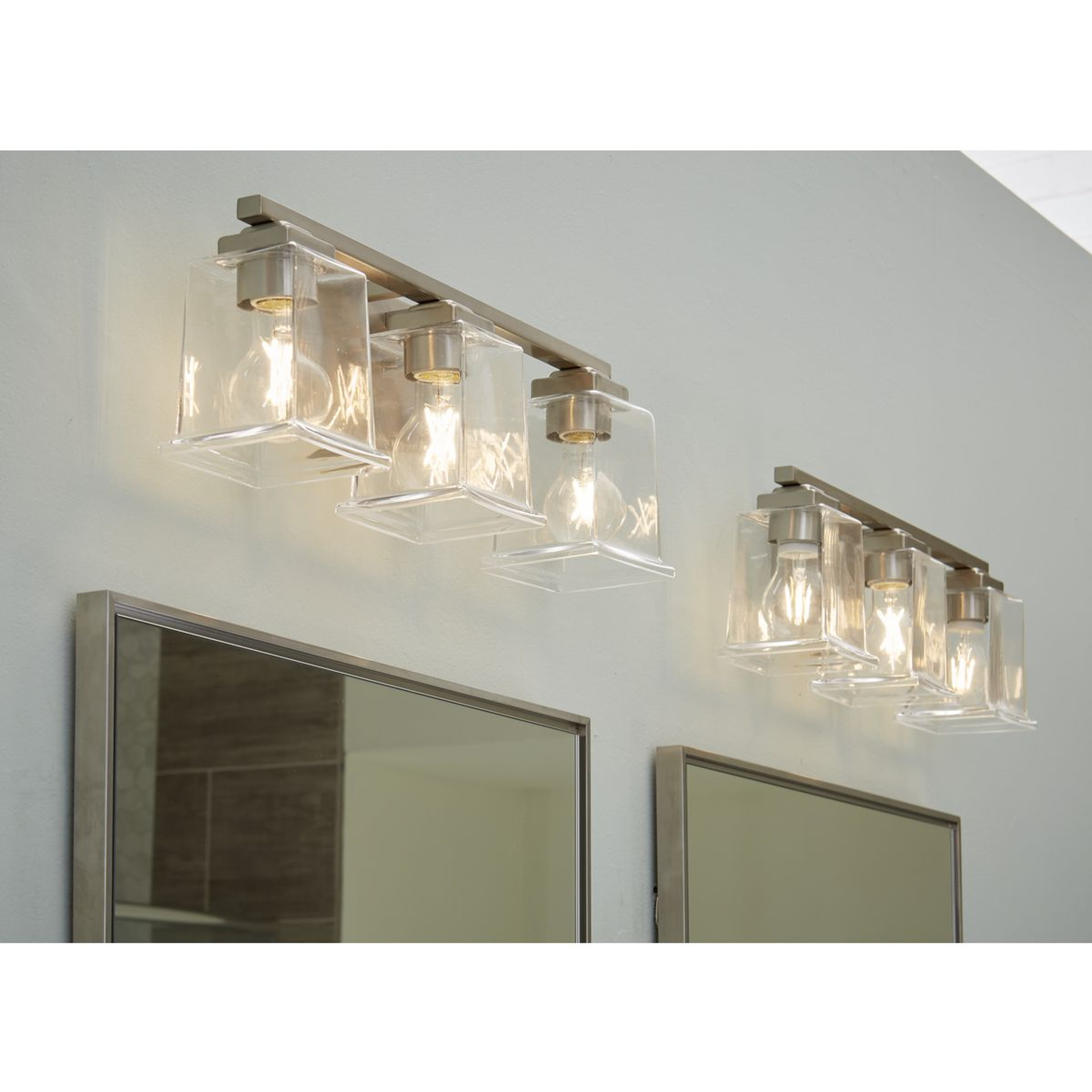 Progress Lighting Gilmour Collection Three-Light Modern Farmhouse Brushed Nickel Clear Glass Bath Vanity Light - Damp Location Listed Application Shot Model P300379-009