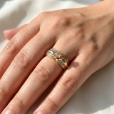 Vintage diamond engagement ring worn on model's hand, 14kt yellow gold with tapered baguette accents