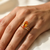 Citrine ring worn on model's hand, marquise cut citrine in 14kt yellow gold solitaire setting