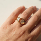 Gold baguette diamond ring, contemporary luxury architectural design macro close-up on models hand