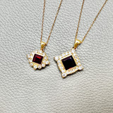 Garnet And diamond halo pendant necklace on display