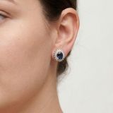Oval sapphire and diamond stud earrings featuring model