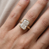 Lab-grown radiant cut diamond engagement ring with hidden diamonds 14kt yellow gold close-up on model