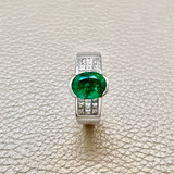 Oval emerald engagement ring with diamond halo in 18kt white gold side profile