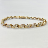 Elegant 7-inch gold bracelet featuring tapered baguette diamonds, G/H color.