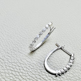 Elegant Diamond Cut Oval Hoop Earrings in 14kt White Gold.