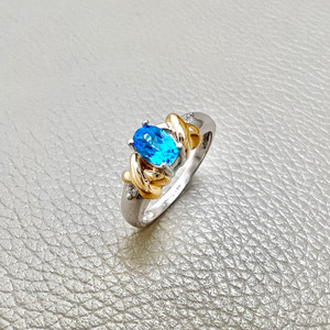14kt two-tone white and yellow gold oval blue topaz diamond ring with 0.39tcw, featuring round diamonds, ideal for a meaningful gift, engagement, or promise ring Treasured & Co.